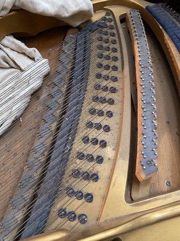 Treble strings on Bluthner grand piano before replacement