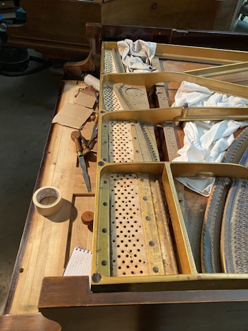 Strings are removed from the Bluthner grand piano